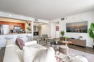 a living room with a white couch and a kitchen at Brickell 2 bedroom condo in the heart of Miami in Miami