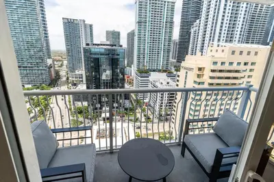 a balcony with two chairs and a table and some buildings at Brickell 2 bedroom condo in the heart of Miami in Miami