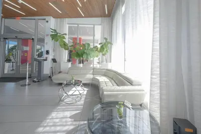 a living room with a couch and a table at 2B 2B Beachfront Pool Gym, and Restaurant in Hallandale Beach