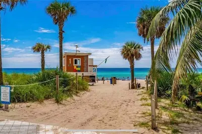 a small shack on the beach with palm trees at Miami Apt with Amazing Views & Kitchen in Hallandale Beach