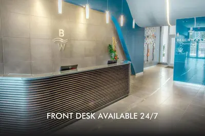 a lobby with a front desk in a building at Beachfront Apt with Pool by the Ocean in Hallandale Beach