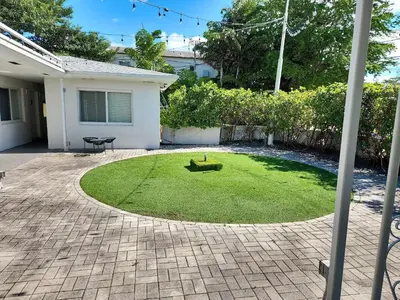 a yard with a circle of grass in front of a house at Stylish Studio Near Miami Relevant Spots in Miami