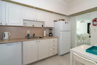 a kitchen with white cabinets and a white refrigerator at Condo on the beach Hollywood 6th floor in Hollywood