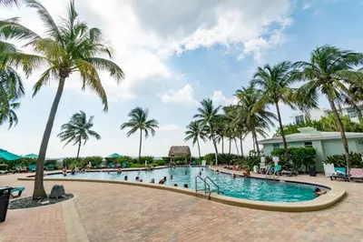 a pool at the resort with palm trees at Condo on the beach Hollywood 6th floor in Hollywood