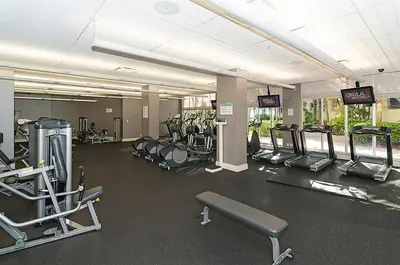 a gym with a lot of cardio equipment in it at Condo on the beach Hollywood 6th floor in Hollywood