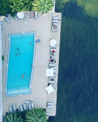 an overhead view of a swimming pool next to the water at Oceanview studio with Pool & Beach in Hallandale Beach
