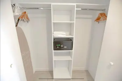 a walk in closet with white shelving at Miami Apartment 2 full size beds & Beach Service in Hallandale Beach