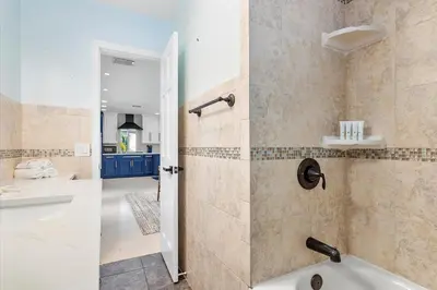 a bathroom with a shower with a tub and a sink at Blue Wave Retreat at Hollywood Beach home in Hollywood