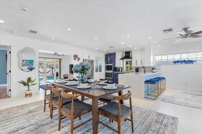 a dining room and kitchen with a table and chairs at Blue Wave Retreat at Hollywood Beach home in Hollywood