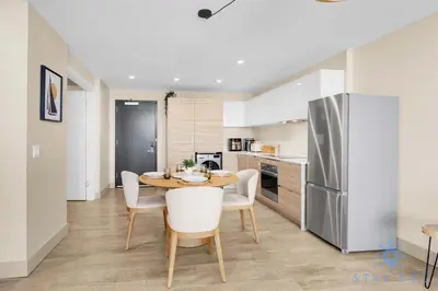 a kitchen with a table and chairs and a refrigerator at Stylish Nice Apt Hollywood Beach Boardwalk in Hollywood