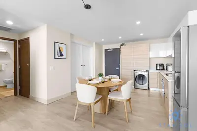 a kitchen and dining room with a table and chairs at Stylish Nice Apt Hollywood Beach Boardwalk in Hollywood