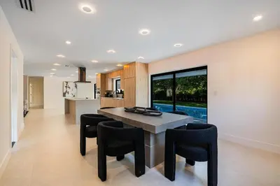 a kitchen and dining room with a table and chairs at Modern Luxury Home with Racket Sports Gym BBQ in Rockdale