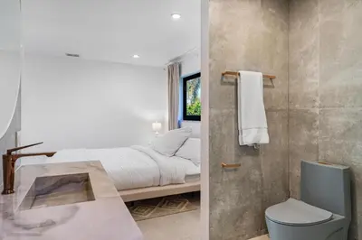 a white bedroom with a bed and a shower at Modern Luxury Home with Racket Sports Gym BBQ in Rockdale