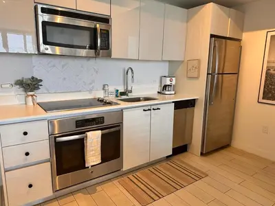 a kitchen with a stainless steel stove and refrigerator at Miami Beach 1B 1B w Kitchen and Beach Service in Hallandale Beach
