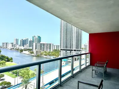 a balcony with a bench and a view of a river at Miami Beach 1B 1B w Kitchen and Beach Service in Hallandale Beach