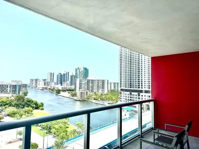 a balcony with a view of a river and buildings at Miami Beach 1B 1B w Kitchen and Beach Service in Hallandale Beach