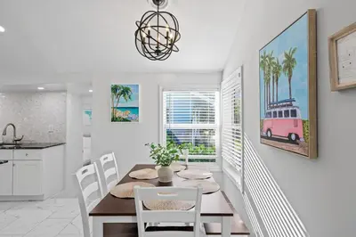 a kitchen and dining room with a table and chairs at Beach Home in Victoria Park in Fort Lauderdale