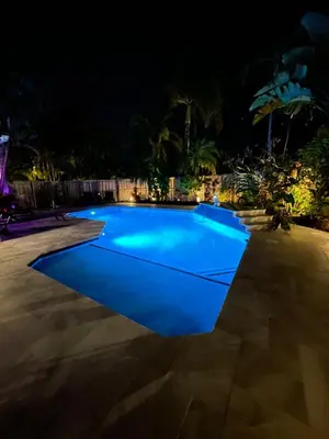 a swimming pool lit up at night at La Dolce Villa in Fort Lauderdale