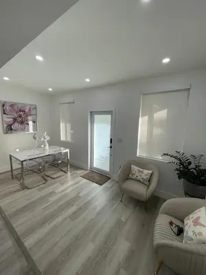 a living room with a table and two chairs at Beautiful House in Coral Gables FL in Miami