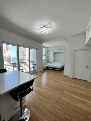 a large living room with a bed and a desk at Fully Equipped Modern Loft in the heart of Miami in Miami