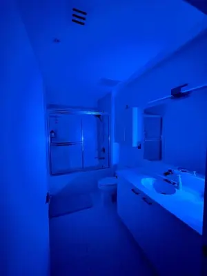 a bathroom with a sink and a toilet in a blue light at Fully Equipped Modern Loft in the heart of Miami in Miami