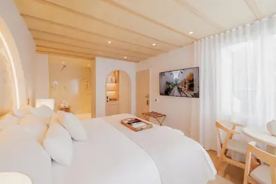 a white bed with white pillows in a bedroom at Donatella Boutique Hotel in Miami Beach