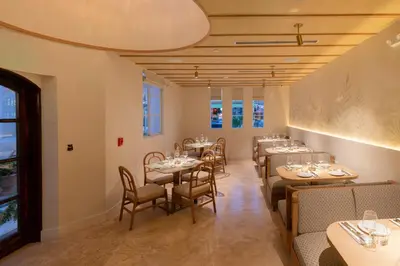 a restaurant with tables and chairs in a room at Donatella Boutique Hotel in Miami Beach