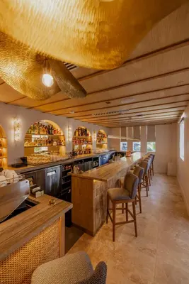 a restaurant with a long line of tables and chairs at Donatella Boutique Hotel in Miami Beach