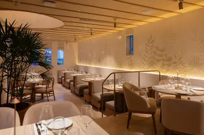a restaurant with tables and chairs in a room at Donatella Boutique Hotel in Miami Beach