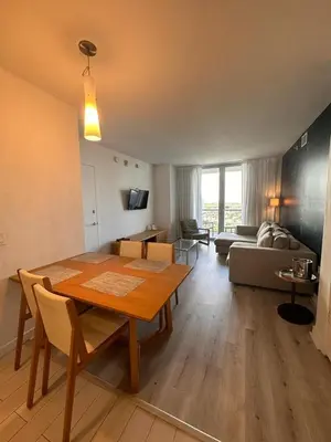 a living room with a table and a couch at Cozy 1BR Retreat wPool BeachService & Full Kitchen in Hallandale Beach