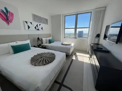 a hotel room with two beds and a television at Best Apartment next to Hollywood Beach 2B 2B in Hollywood