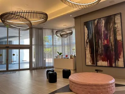 a living room with a round table and two chandeliers at Best Apartment next to Hollywood Beach 2B 2B in Hollywood