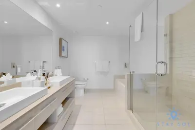 a white bathroom with two sinks and a shower at Bay View 2Br Apartment with Amenities in Hollywood