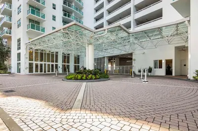 a large building with a courtyard in front of it at BrickellRiver LOFT with parking & 12 min to South Beach in Miami