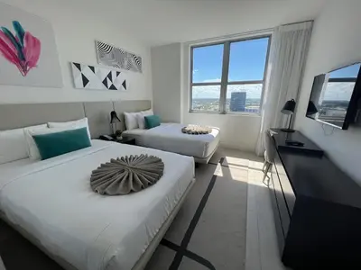 a hotel room with two beds and a television at Hyde the best apartment next to Hollywood Beach 2B 2B in Hollywood