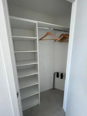 a walk in closet with white shelves at Hyde the best apartment next to Hollywood Beach 2B 2B in Hollywood