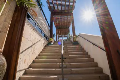 a staircase leading up to a building with the sun in the background at Studio 2b 1b with Beach and Pool Miami Beach in Hallandale Beach