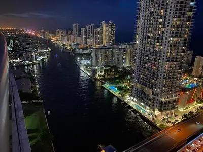 a view of a city at night with a river at Amazing Studio at Hallandale Beach with service beach in Hallandale Beach