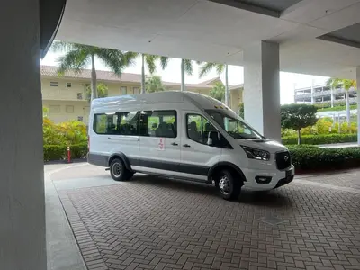 a small white van parked under a building at Comfy Apt 2 Queen Beds with Pool & Beach in Hallandale Beach