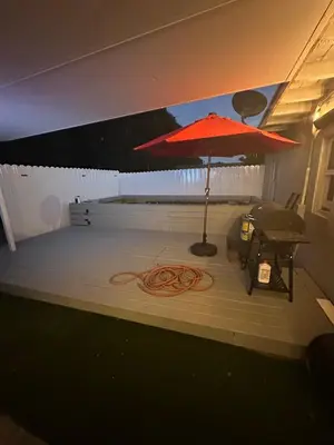 a red umbrella sitting on top of a patio at Luxury Entertainment home Hard rock stadium in Opa-locka