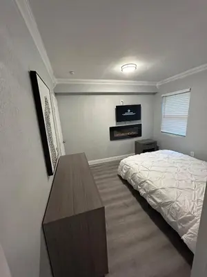 a bedroom with a bed and a wooden table at Luxury Entertainment home Hard rock stadium in Opa-locka