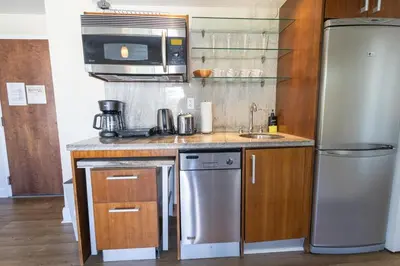 a kitchen with a stainless steel refrigerator and a sink at Amazing 1 Bedroom with Rooftop Pool D309 in Miami Beach