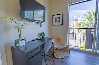 a office with a desk with two chairs and a window at Amazing 1 Bedroom with Rooftop Pool D309 in Miami Beach