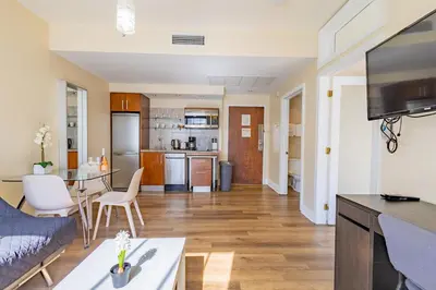 a living room and kitchen with a couch and a table at Amazing 1 Bedroom with Rooftop Pool D304 in Miami Beach