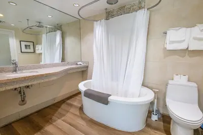 a bathroom with a tub and a toilet and a sink at Beautiful 1 Bedroom with Rooftop Pool D203 in Miami Beach