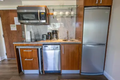 a small kitchen with a sink and a refrigerator at Beautiful 1 Bedroom with Rooftop Pool D203 in Miami Beach