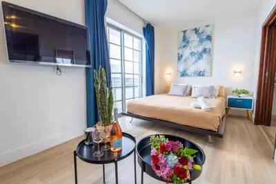 a living room with a bed and a tv at Studio with rooftop pool on Ocean Dr B303 in Miami Beach