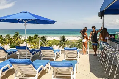 a man and a woman are standing on the beach at Studio with rooftop pool on Ocean Dr B303 in Miami Beach