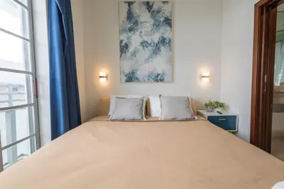 a bedroom with a large bed with two pillows at Studio with rooftop pool on Ocean Dr B303 in Miami Beach