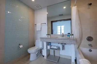 a bathroom with a sink and a toilet and a mirror at Beautiful Studio with Rooftop pool B309 in Miami Beach